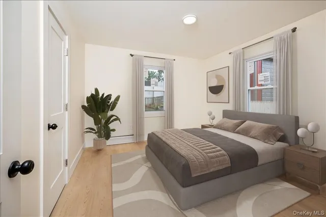 a bedroom with a large bed and a potted plant