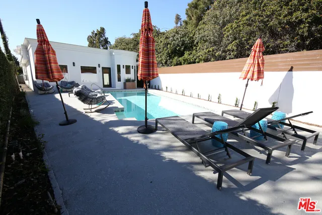 a view of a patio with table and chairs