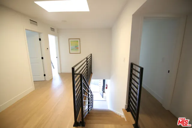 a view of a hallway with wooden floor and entryway