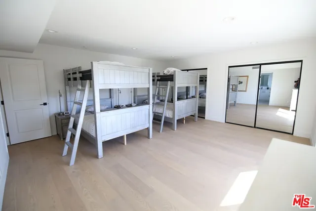 a bedroom with furniture and a wooden floor