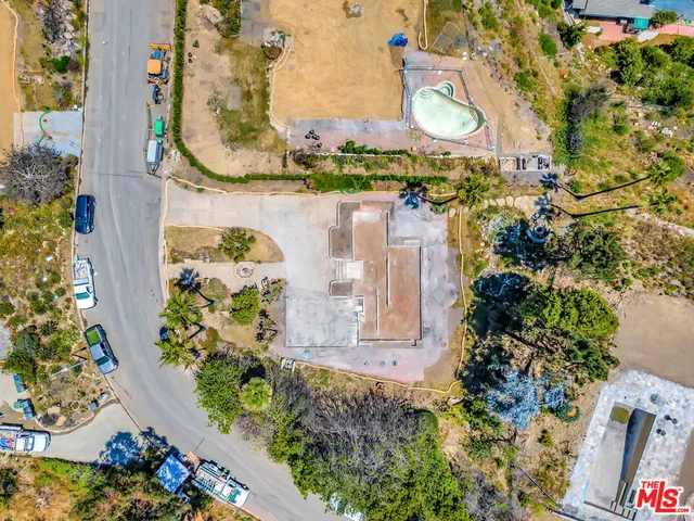 an aerial view of a houses with a yard