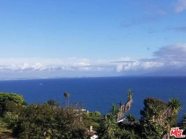 a view of a yard with a wooden fence