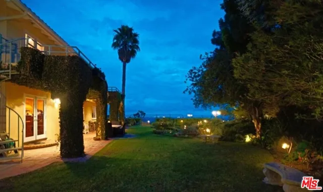 a view of a city street with a building and trees