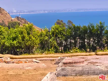 a view of a yard with an ocean view