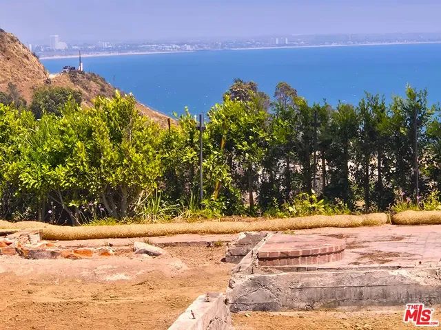 a view of a yard with an ocean view