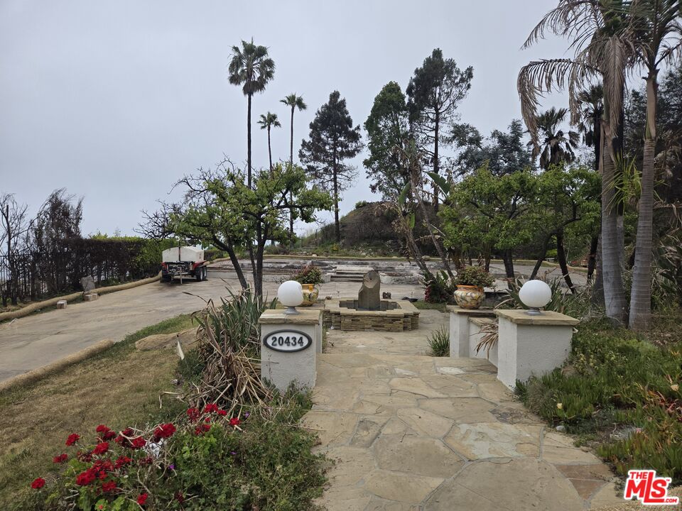 20434 Seaboard Road Malibu, CA 90265 - Photo 9 of 37 a view of a fire pit with flower plants