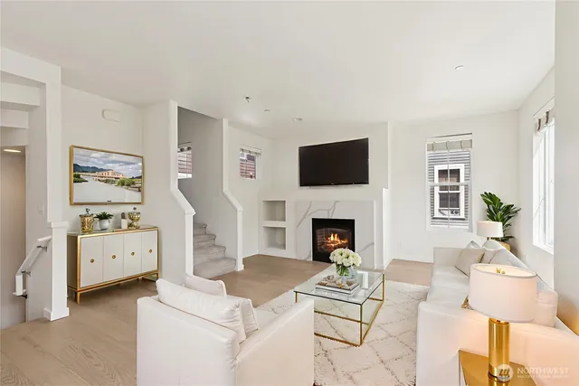 a living room with furniture a flat screen tv and a fireplace