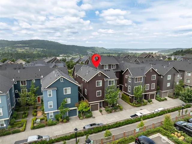 an aerial view of residential houses with outdoor space