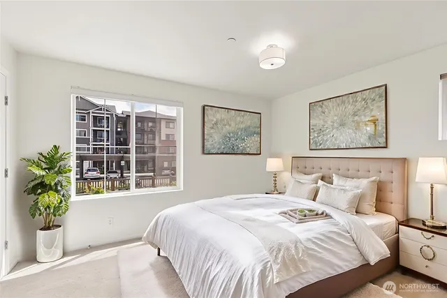 a bedroom with a large bed and a window