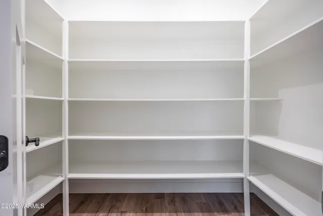 a view of walk in closet with empty racks