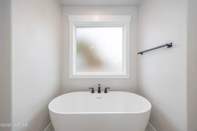 a white bath tub sitting in a bathroom