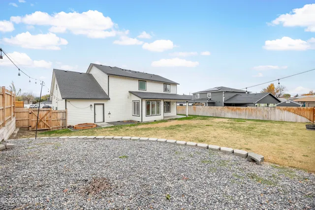 a view of a house with pool and chairs