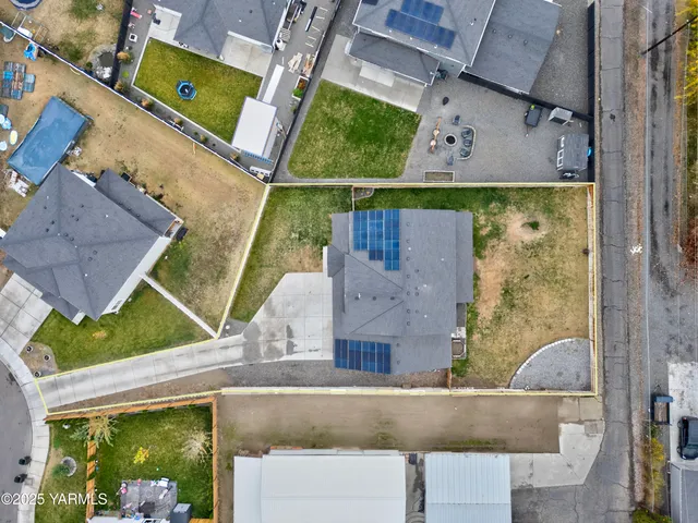 an aerial view of a house with a yard