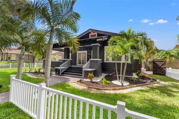 a view of a house with backyard porch and sitting area