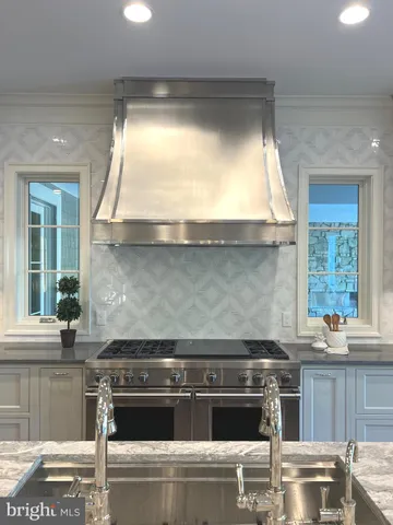 a bathroom with a granite countertop sink a toilet a mirror and shower