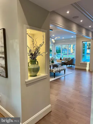 a bedroom with a bed a dresser next to a window