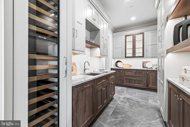 a kitchen with kitchen island granite countertop a sink and a stove