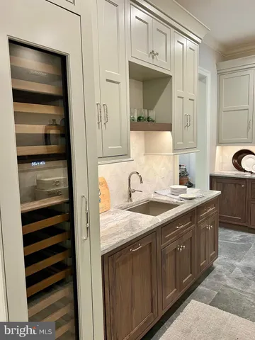 a kitchen with stainless steel appliances granite countertop a sink cabinets and wooden floor