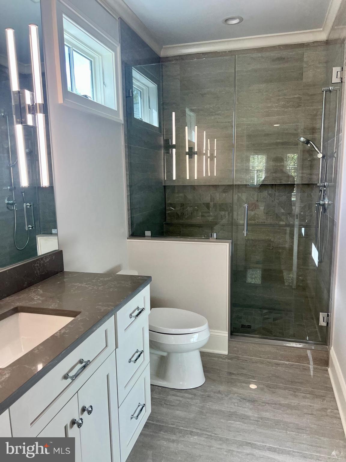 314 Golf Course Road Owings Mills, MD 21117 - Photo 61 of 112 a bathroom with a granite countertop sink a toilet a mirror and shower