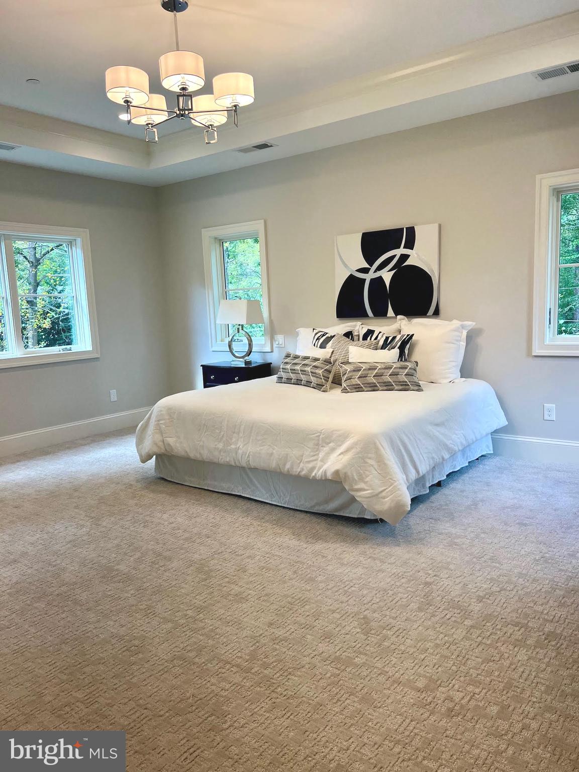 314 Golf Course Road Owings Mills, MD 21117 - Photo 62 of 112 a bedroom with a large bed and a chandelier