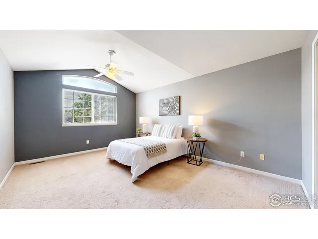 a living room with a bed furniture and a window