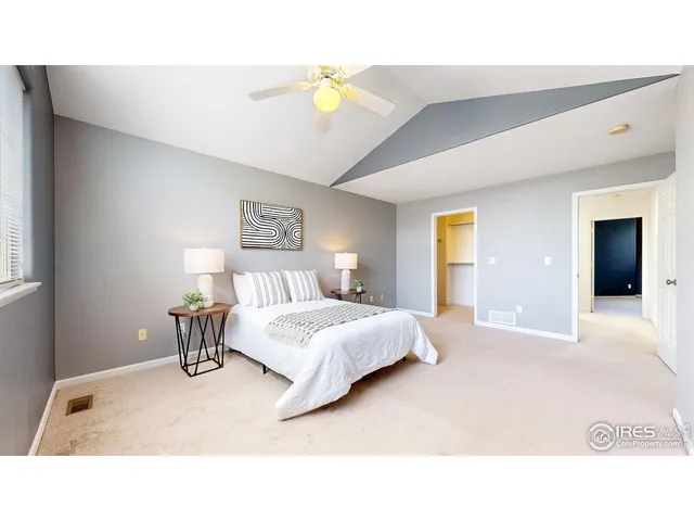 a bedroom with a bed and a painting on the wall