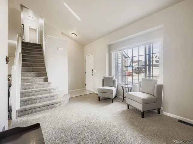 a living room with furniture and a large window