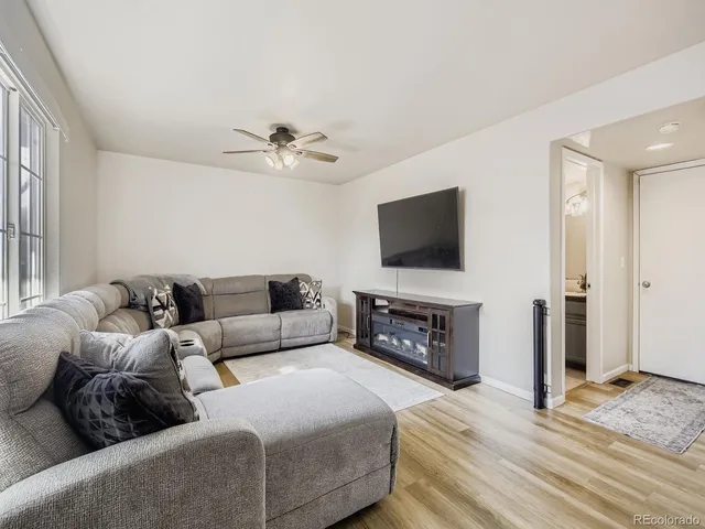 a living room with furniture a fireplace and a flat screen tv