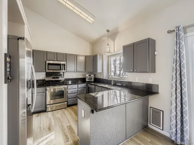 a kitchen with a sink stove and refrigerator