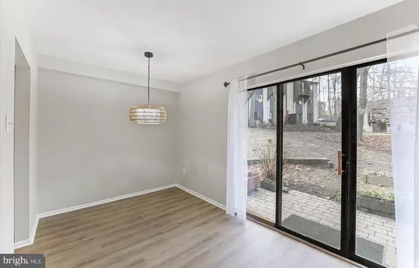 a view of a room with wooden floor and window