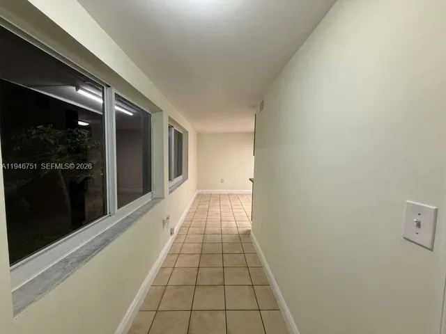 a hallway with a black white checkered floor