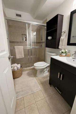 a bathroom with a toilet sink and shower