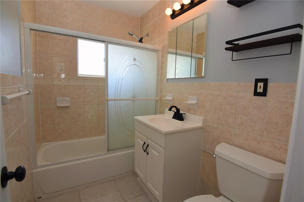 21572 Edgewater Drive Port Charlotte, FL 33952 - Photo 12 of 15 a bathroom with a sink a toilet and shower