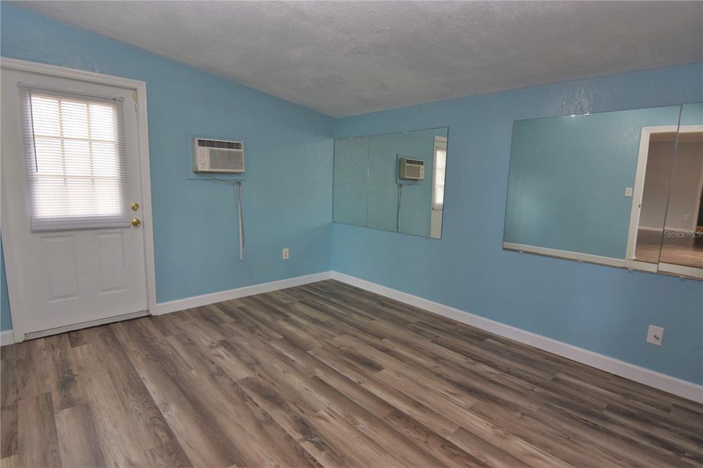 21572 Edgewater Drive Port Charlotte, FL 33952 - Photo 13 of 15 a view of empty room with wooden floor and fan