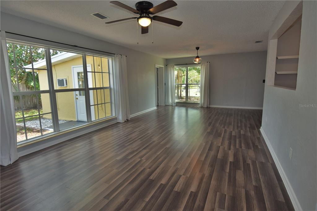 21572 Edgewater Drive Port Charlotte, FL 33952 - Photo 2 of 15 wooden floor in an empty room with a window