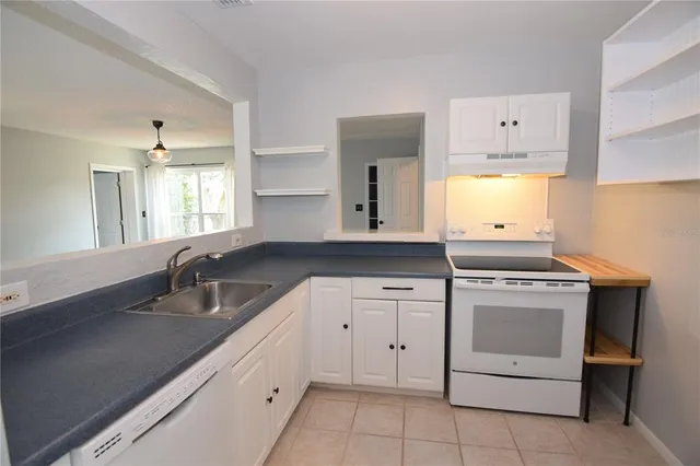 a kitchen with cabinets appliances and a sink
