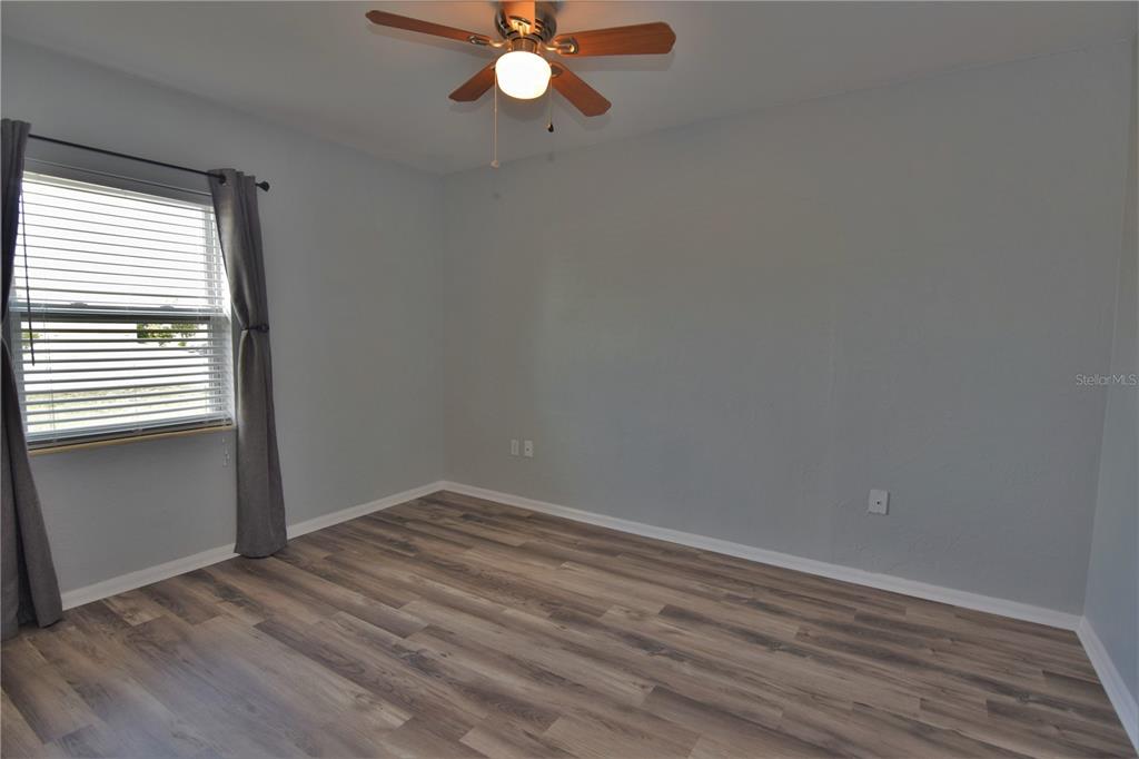 21572 Edgewater Drive Port Charlotte, FL 33952 - Photo 7 of 15 a view of a room with wooden floor and fan