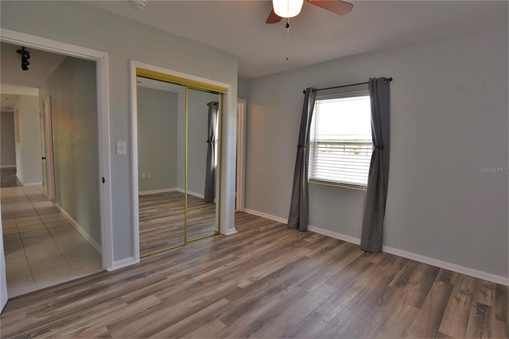 21572 Edgewater Drive Port Charlotte, FL 33952 - Photo 8 of 15 an empty room with wooden floor closet and windows