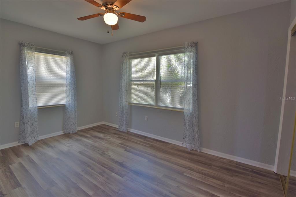 21572 Edgewater Drive Port Charlotte, FL 33952 - Photo 10 of 15 an empty room with wooden floor and windows
