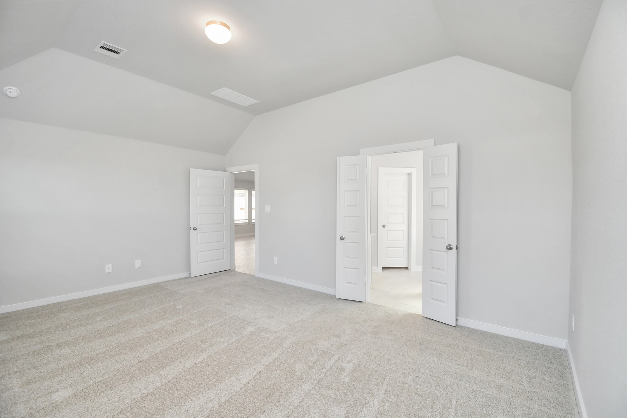 14619 Diamond Dove Lane Houston, TX 77049 - Photo 22 of 33 Escape and relax in the exquisite primary suite, a haven to unwind after a long day. The spacious room, boasts plush carpeting, soothing paint tones, high ceilings, and expansive windows adorned with privacy blinds. Sample photo of completed home with similar floor plan. Actual colors and selections may vary.