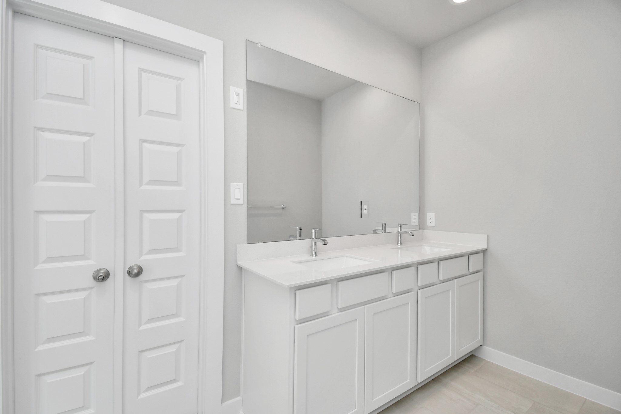 14619 Diamond Dove Lane Houston, TX 77049 - Photo 26 of 33 Elevate your daily routine at the elegant vanity, now equipped with double sinks, light countertops, modern hardware, and beautiful recessed lights. Sample photo of completed home with similar floor plan. Actual colors and selections may vary.
