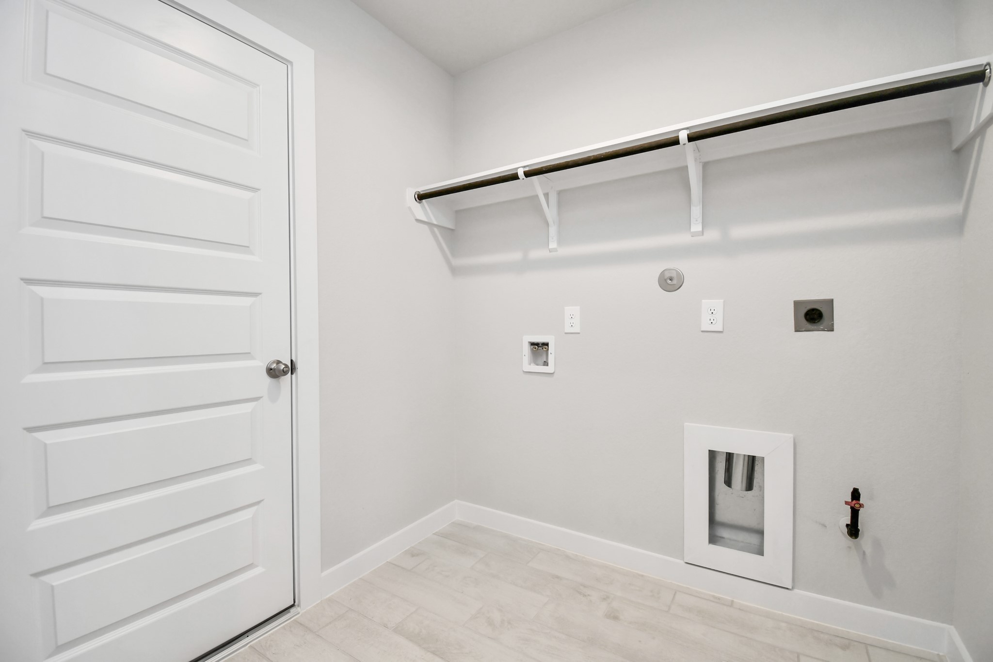 14619 Diamond Dove Lane Houston, TX 77049 - Photo 32 of 33 A perfect blend of functionality and comfort. Capture the essence of easy living with a first-floor laundry room, thoughtfully equipped with shelving for effortless organization. Both electric and gas connections available. Sample photo of completed home with similar floor plan. Actual colors and selections may vary.