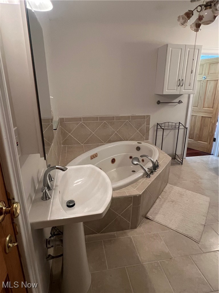 6171 Barrett Road Geneva, OH 44041 - Photo 35 of 38 Full bath featuring a tub with jets and light tile patterned floors