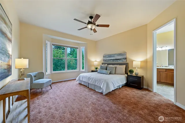 a spacious bedroom with a bed and a chandelier