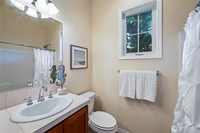 a bathroom with a sink toilet and mirror