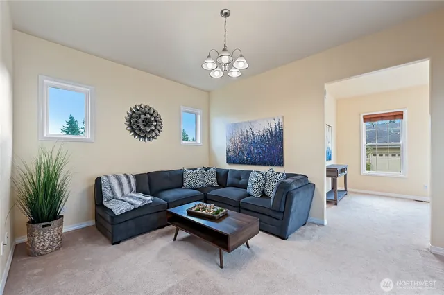 a living room with furniture and a chandelier