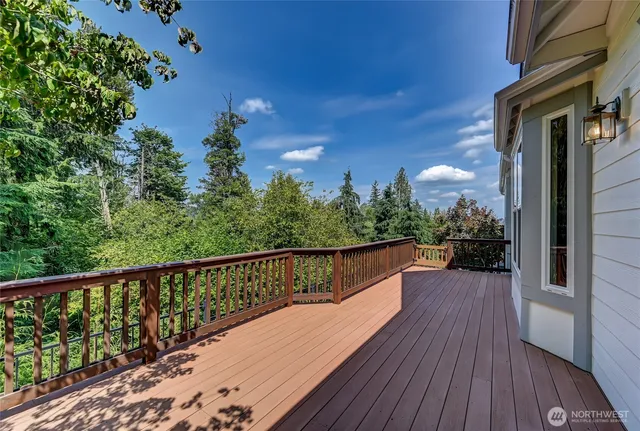 a view of balcony with wooden floor and fence