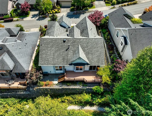 an aerial view of a house with a garden and lake view