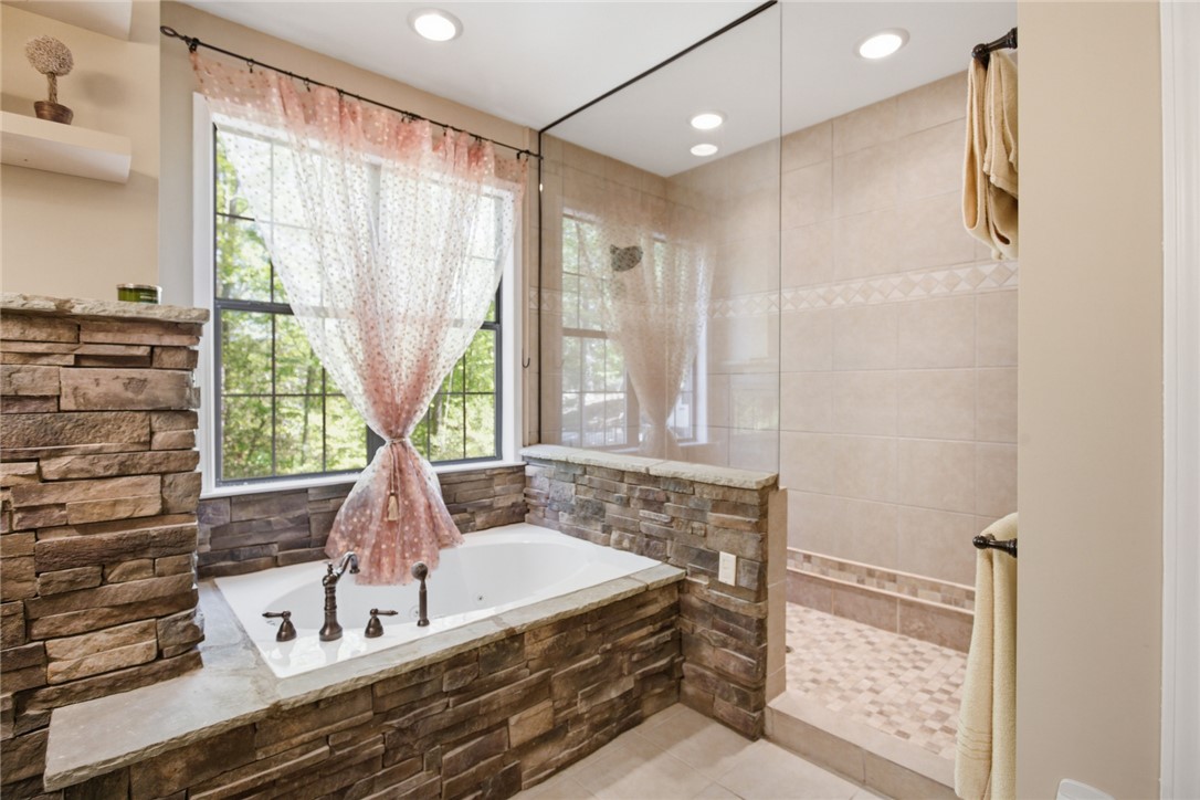 215 Inlet Pointe Drive Anderson, SC 29625 - Photo 11 of 47 Relax and unwind in this serene bathroom, featuring a luxurious soaking tub and spacious shower.