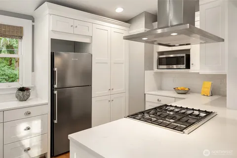 a kitchen with a refrigerator and a stove